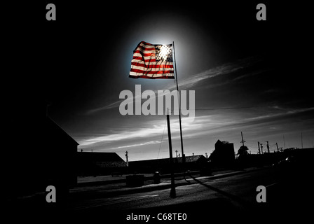 Immagine in bianco e nero della bandiera americana in cui il flag è illuminato dal sole ed è mostrato in colore. Foto Stock