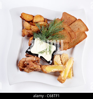 Ali di pollo, patate fritte con sesamo e croste secche isolato su bianco con il tracciato di ritaglio Foto Stock