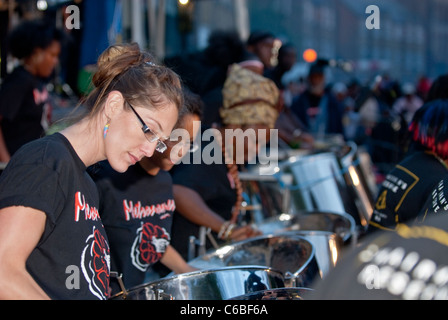 Membro della band da acciaio Metronomes orchestra che suona tamburo di acciaio a Notting Hill Campionati del panorama Foto Stock