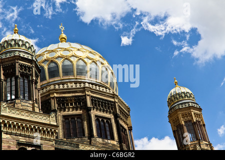 La sinagoga sotto il cielo blu con nuvole a Berlino splende in oro Foto Stock