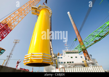 Una gru solleva un pezzo di transizione sul ponte di una chiatta, pronto per estrarre il Walney offshore wind farm Foto Stock