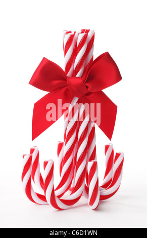 Close up candy canes legate con nastro bow su sfondo bianco Foto Stock