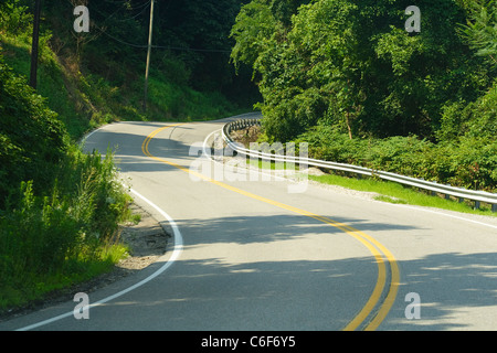 Avvolgimento, curva road in montagna vicino alla cabina Creek, WV su una mattina di sole in estate. Foto Stock