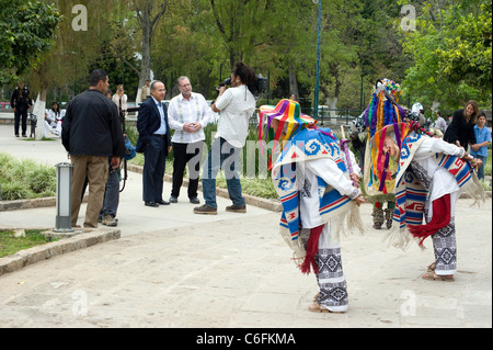 Il presidente Felipe Calderon e Peter Greenberg con artisti in costume nel parco di Morelia, in Messico, mentre sua moglie e suo figlio guardano avanti (estrema destra). Foto Stock