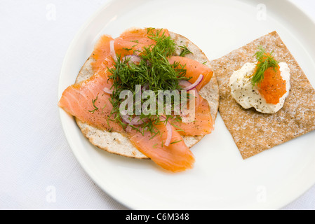 Pane fresco guarnita con salmone affumicato e aneto fresco, panna acida e uova di salmone Foto Stock