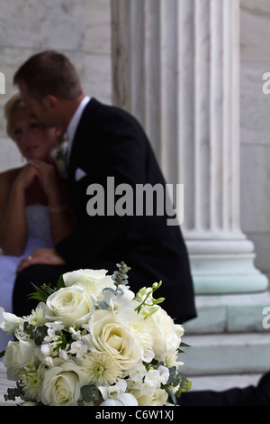 Coppia di nozze una sposa con uno sposo con bouquet di rose bianche sfondo sfocato verticale a Toledo Ohio USA alta risoluzione Foto Stock