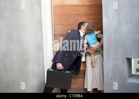 Il marito bacia la moglie prima del lavoro Foto Stock