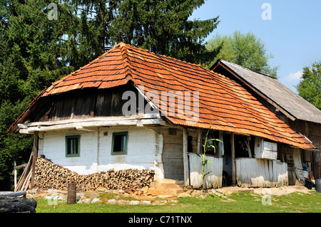 Tradizionale cottage in legno con legna da ardere impilata, nei pressi di Karlovac, Croazia, Agosto 2008. Foto Stock