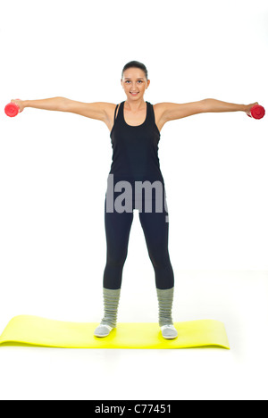 Giovane donna in nero sport tuta rossa di sollevamento barbell Foto Stock