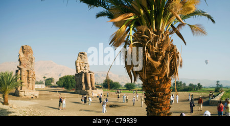 Vista panoramica di turisti presso i Colossi di Memnon sulla riva occidentale del Fiume Nilo a Luxor, Egitto Foto Stock