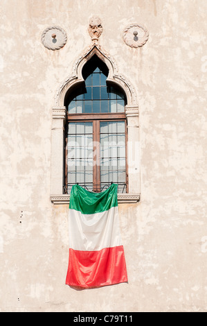 La bandiera italiana visualizzata su una finestra Foto Stock