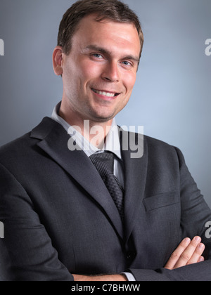 Ritratto di un uomo sorridente che indossa un abito grigio Foto Stock