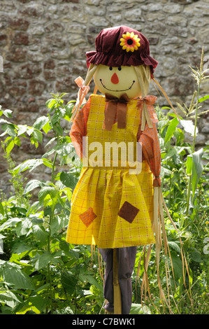 Female lady scarecrow sold for use on allotments, vegetable and fruit gardens Foto Stock