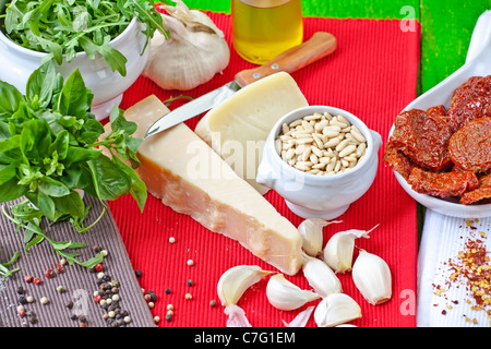 Gli ingredienti freschi per il pesto Tricolore con basilico, rucola, grana, pecorino, pinoli, pomodoro secco e aglio Foto Stock