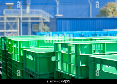 Verde di cassette in plastica. Sfocato sfondo blu Foto Stock