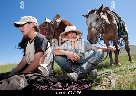 Pastore mongolo ragazzi prendono pausa sulla steppa, Mongolia Foto Stock