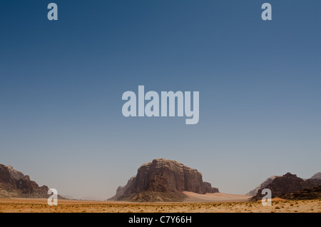 Lasciando il Wadi Rum Desert dopo 3 giorni sul cammello indietro, Rum Village è a sinistra scindono al riparo dalla centrale di affioramento Foto Stock