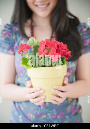 Donna coreana azienda pianta in vaso Foto Stock