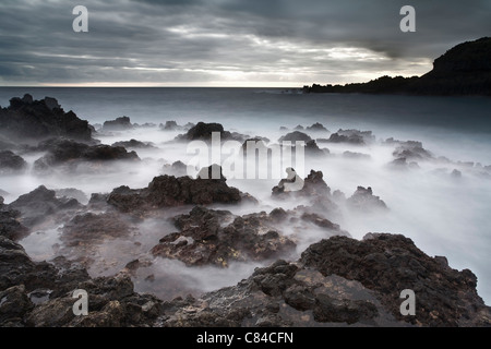 Foggy formazioni rocciose sulla spiaggia Foto Stock