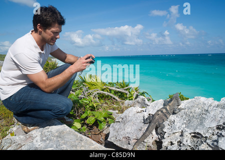 Uomo di scattare una foto di Iguana, Reef Playacar Resort e Spa, Playa del Carmen, Messico Foto Stock