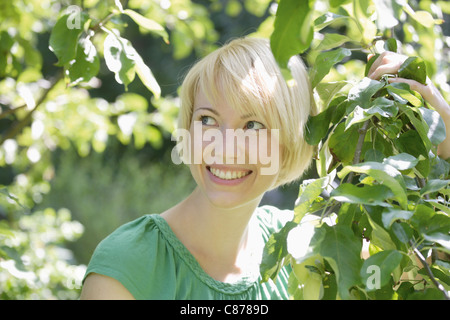 In Germania, in Baviera, Schaeftlarn, ravvicinata di una giovane donna nel parco, sorridente Foto Stock