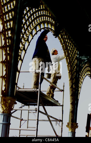 Operai che dipingono gli archi lungo gli archi di Madeira Drive di Brighton sul lungomare 2001 Foto Stock