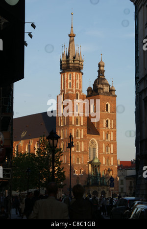 Mariacki Basilica, la più bella chiesa polacca illuminata dal tramonto, è visto dal Szczepanska street in Cracov, Polonia. Foto Stock