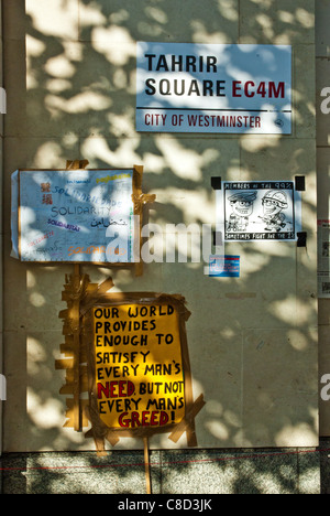 St Pauls, Londra, anti camp capitalista. Poster sulla parete 'Piazza Tahrir' e 'questo mondo fornisce sufficiente ad ogni uomo il bisogno di..." Foto Stock