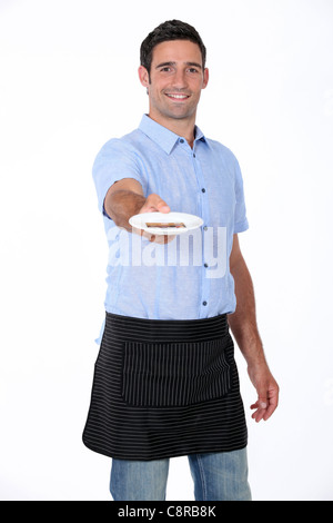 L'uomo tenendo fuori piattino Foto Stock