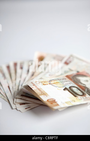 Dieci pound note sparse su sfondo bianco Foto Stock