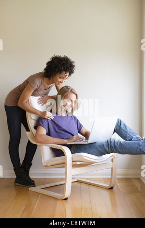 Stati Uniti, California, Los Angeles, giovane donna guardando l'uomo utilizzando portatile a casa Foto Stock