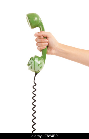 Femmina lato tenendo un auricolare verde da un telefono vintage Foto Stock