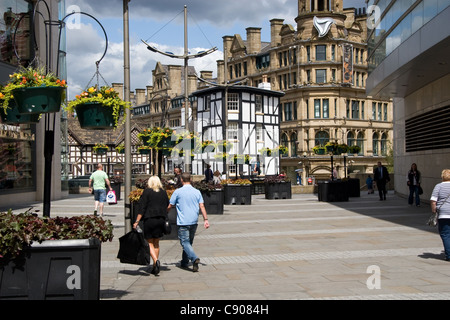 Gli amanti dello shopping, off Market St, cercando di Sinclair pub e triangolo, City Centre, Manchester, Regno Unito Foto Stock