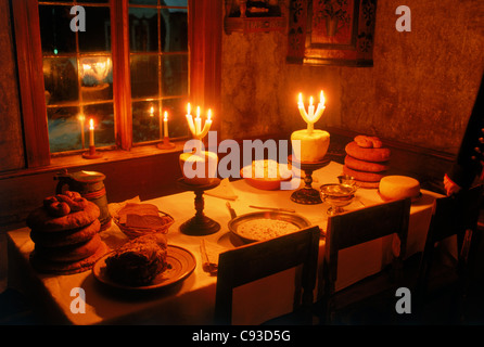 Vecchio svedese tavola di Natale o julbord da 1850s a Skansen a Stoccolma con formaggio, pane, prosciutto arrosto e le candele Foto Stock