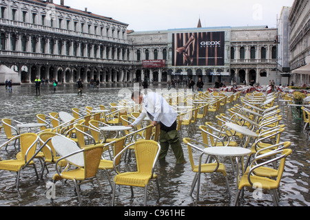 A preparare i tavoli per gli ospiti. -- Acqua alta in piazza San Marco, Venezia, Italia Foto Stock