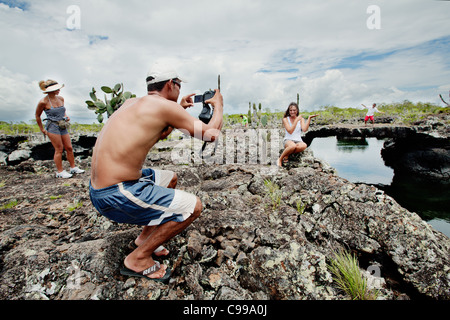 Turistica prendendo le fotografie a Los Tuneles island / snorkeling sito nelle vicinanze di Isabela island, Galapagos, Ecuador. Foto Stock