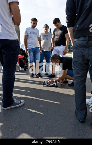 La folla gamble indovinare quale cup la palla è sotto all'ombra del Big Ben sul Westminster Bridge, Londra. Foto Stock