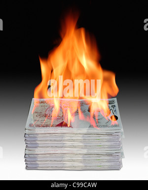 Pila di banca britannica note sul fuoco. Foto Stock