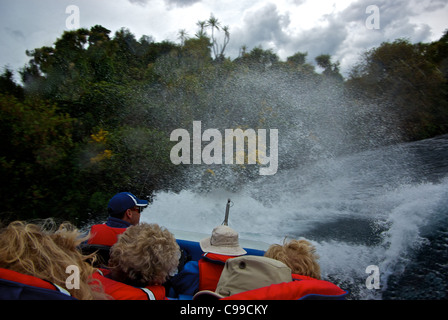 Inzuppando spray schiumogeno ad alta velocità la sfocatura in movimento durante la Cascate Huka jet boat 360 gradi di spin sul fiume Waikato in Nuova Zelanda Foto Stock