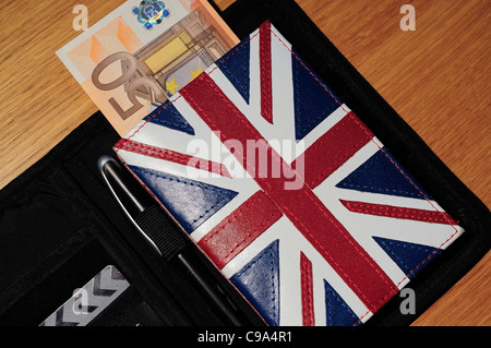 Regno Unito passaporto e titolare con una cinquantina di euro pound nota. Come la valuta Euro del debito si aggrava la crisi verrà UK soggiorno in Europa Foto Stock