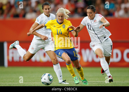 Josefine Oqvist di Svezia (C) aziona la sfera contro gli USA i giocatori Carli Lloyd (L) e Alex Krieger (R) durante la Coppa del Mondo di calcio. Foto Stock