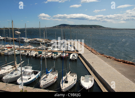 Barche a vela ormeggiata a Bouzigues' marina di Thau con montatura St-Clair di Sète a distanza, Languedoc-Roussillon Foto Stock