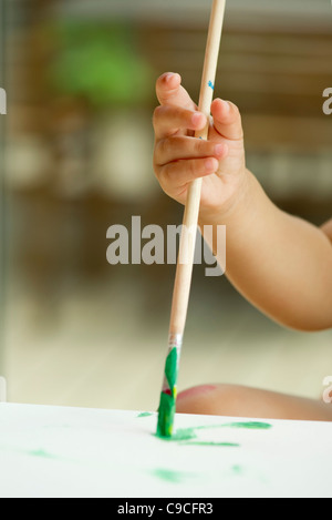Bambino la mano che regge il pennello Foto Stock