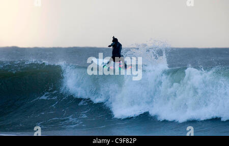 13 dic 2011 - Swansea, Regno Unito - surfista locale Simon soffiante rendendo la maggior parte della pesante surf la laminazione in Langland Bay, Swansea questa mattina come il Galles del Sud Costa è colpita dal forte vento e pioggia come gli avvisi meteo sono rimasti sul posto. Foto Stock