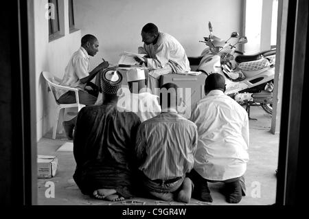 Sett. 18, 2010 - Kura, Kano, NIGERIA - mentre gli uomini di pausa a pregare, Ward Kwciri IPD persona focale Auwalu Sulaiman seduto, conta conta alla fine del primo giorno della campagna di immunizzazione. .Fanatismo religioso e disinformazione hanno costretto gli abitanti di un villaggio nel nord musulmano della Nigeria nel rifiuto di polio vac Foto Stock