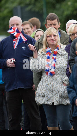 I membri della folla in attesa per l arrivo del 2012 Torcia Olimpica a Consett, County Durham il 16 giugno. Foto Stock