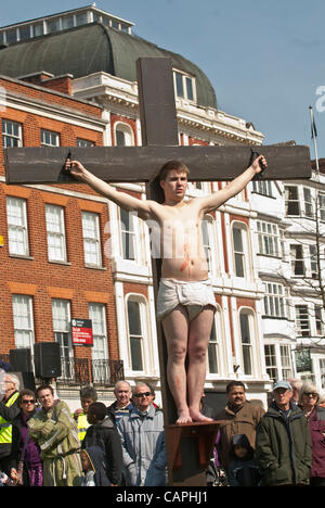 Exeter, Regno Unito. 06 Aprile, 2012. Attore che interpreta Dismas è crocifisso accanto a Gesù durante il Venerdì Santo a piedi di testimonianza sulla Cattedrale di Exeter Green Foto Stock