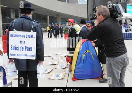 Il 1 maggio, 2012, un piccolo gruppo di occupare Toronto manifestanti, fiancheggiata da media e forze di polizia, anche se pochi se qualsiasi pubblico, emanare un pezzo di teatro di strada in base al movimento dei pezzi su una scacchiera, a Nathan Philips Square, Municipio di Toronto, Ontario, Canada. Foto Stock