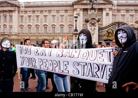 LONDON, Regno Unito - 18 Maggio 2012: occupare Londra e anonimo manifestanti di fronte a Buckingham Palace denunciando la presenza del Re del Bahrein e altro paese leader in visita a Buckingham Palace per la Regina per il Giubileo. Foto Stock