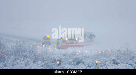 Spazzaneve battaglia per cancellare neve spessa dall'Aeroporto Gatwick di Londra la pista durante una bufera di neve. Foto Stock